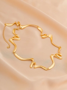 Detail of gold liquid lava choker with irregular wavy metal texture and lobster clasp