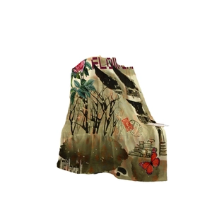 Vintage flannel blanket with butterfly and floral print against a clean white background