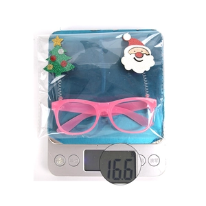 Close-up of pink Christmas LED glasses featuring a Santa and tree on a digital scale