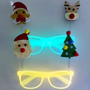 Detail of Christmas LED glasses featuring Santa and tree decorations with glowing frames