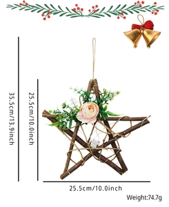 Detail of star-shaped Christmas wreath with twigs, pink flowers and LED fairy lights