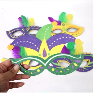 Detail of four colorful Mardi Gras masks with feathers in purple green and gold colors