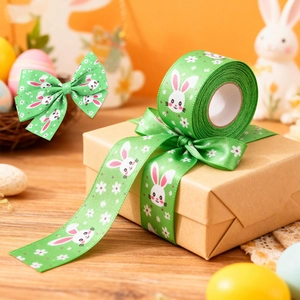 Green Easter ribbon with white rabbit pattern on gift box and a decorative roll
