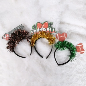 Three sequined Super Bowl party headbands with football charms on a white plush surface