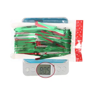 Detail view of 1x2m red and green tinsel curtain showing 80.5g weight on a digital scale