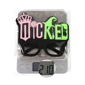 Close-up of Wicked party glasses with crown and witch motifs in pink and green felt