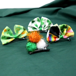 Detail of St. Patrick's Day hair clips with clover patterns and colorful ribbon bows