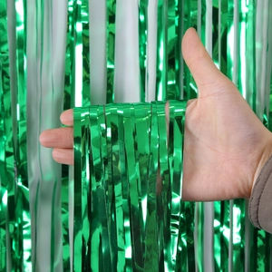 Vibrant green metallic tinsel curtain for Christmas party decoration shown in close-up