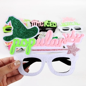 Close-up of glitter felt party glasses with popular text and pink princess crown