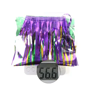 Weight measurement detail of purple, gold and green tinsel fringe skirt showing 56.6g