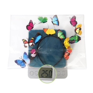Macro shot showing the colorful 3D butterfly headband on an electronic scale weighing 25g