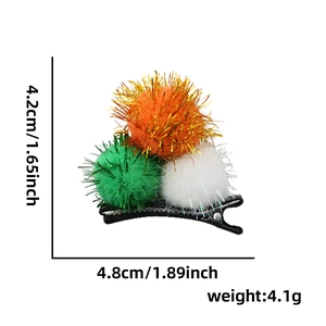St. Patrick's Day hair clip with orange white and green plush balls on duckbill clip