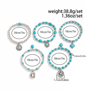 Detail of bohemian turquoise beaded bracelet set with five assorted alloy charms