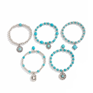 5-piece Bohemian turquoise bead bracelet set with vintage silver charms on white background