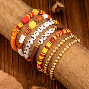 Detail of Thanksgiving fall bracelets with maple leaf charms and colorful heishi beads