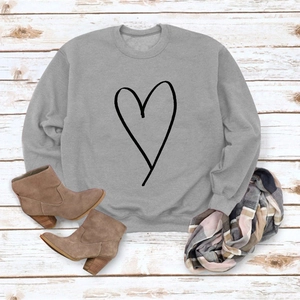 Flat lay of gray long-sleeve sweatshirt with heart line art on rustic wood