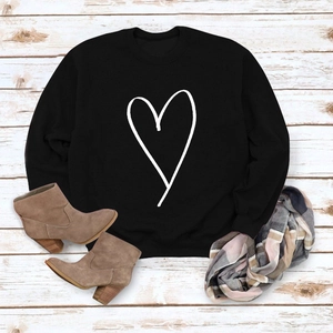 Flat lay of black crewneck sweatshirt with heart print, styled for autumn and winter
