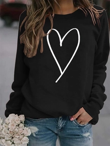 Detail of a casual black long-sleeve sweatshirt featuring a white hand-drawn heart print