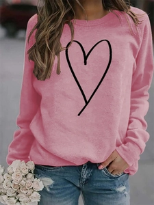 Detailed view of pink crewneck sweatshirt with minimalist black heart line graphic print