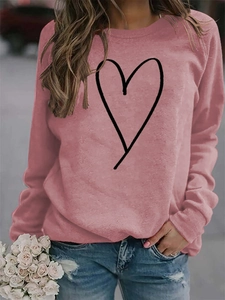 Pink crew neck sweatshirt featuring minimalist black heart print on chest and long sleeves