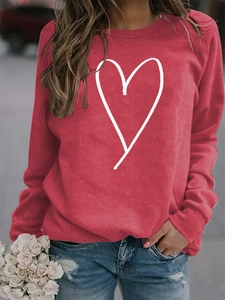 Close-up of red crew neck sweatshirt with white heart line print and hand-held roses