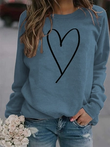 Close-up of minimalist black line heart print on a hazy blue crewneck sweatshirt