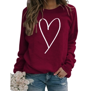 Close-up of burgundy crewneck sweatshirt featuring a white line art heart graphic