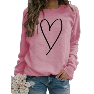 Detail of pink crewneck sweatshirt featuring a minimalist black line heart print
