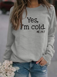 Detail of grey sweatshirt showing 'Yes, I'm cold. ME 24:7' graphic print texture