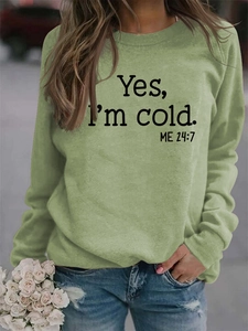 Detail of light green sweatshirt fabric texture with black Yes I'm Cold letter print