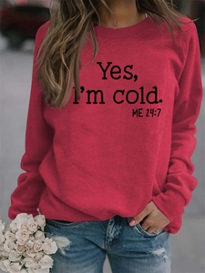Detailed view of red crewneck sweatshirt with Yes I'm cold print worn by a model
