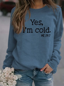 Detail of foggy blue sweatshirt showing Yes I'm Cold 24:7 letter print and crew neck