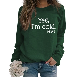 Detail of dark green crewneck sweatshirt with white Yes I'm cold funny slogan print