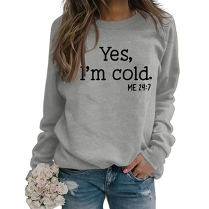 Detail of grey crewneck sweatshirt featuring Yes I'm cold ME 24:7 black printed text