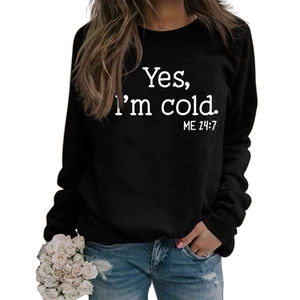 Detail of loose black crewneck sweatshirt with white Yes I'm Cold letter print texture