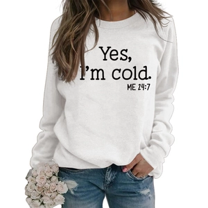 Detail of the 'Yes I'm Cold ME 24:7' printed slogan on white crewneck sweatshirt fabric