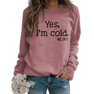 Detail of dusty rose sweatshirt with black Yes I'm cold Me 24:7 slogan print