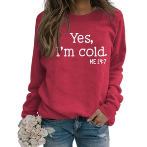 Detail of red crewneck sweatshirt with white 'Yes I'm cold' print for casual winter wear