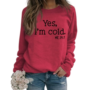 Detail of red crewneck sweatshirt featuring Yes I'm cold artistic letter print and soft fabric