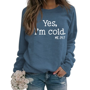 Close-up of blue sweatshirt with white Yes I'm cold ME 24:7 slogan print and rib cuffs