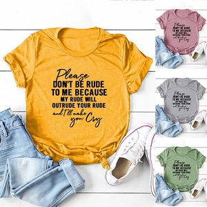 Flat lay of yellow cotton t-shirt with slogan, blue jeans, and canvas sneakers on wood