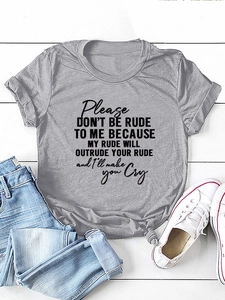 Detail of grey crewneck t-shirt with Please Don't Be Rude slogan on white wood background