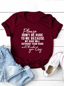 Detail of burgundy T-shirt with 'please don't be rude' print styled with jeans and sneakers