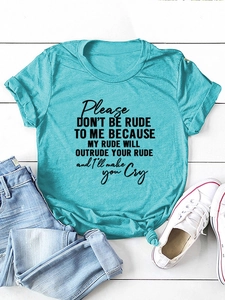 Flat lay of teal slogan T-shirt with rolled sleeves and front knot detail on white wood