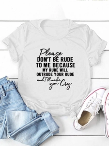 Flat lay of white cotton slogan tee with denim jeans and sneakers on wood background