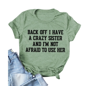 Relaxed round neck bean green T-shirt with black slogan print and blue jeans