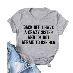 Detail of grey crewneck T-shirt with black text print and stylish front knot hem detail