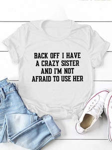 Flat lay of white crew neck t-shirt with slogan print and stylish front knot detail