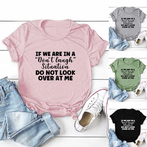 Detail of t-shirt with front quote print and stylish front-knot hem in various colors