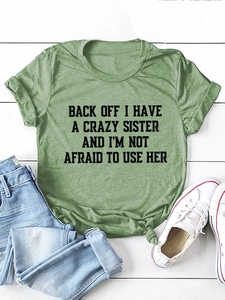 Detail of army green crewneck t-shirt with front slogan print and stylish hem knot